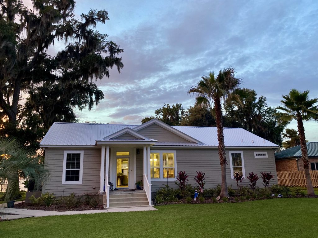 Standing seam metal roof on a single-story Florida home at dusk