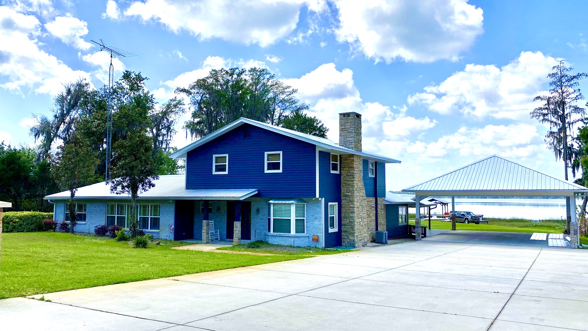 Standing seam metal roof on a waterfront Florida home with a metal dock cover