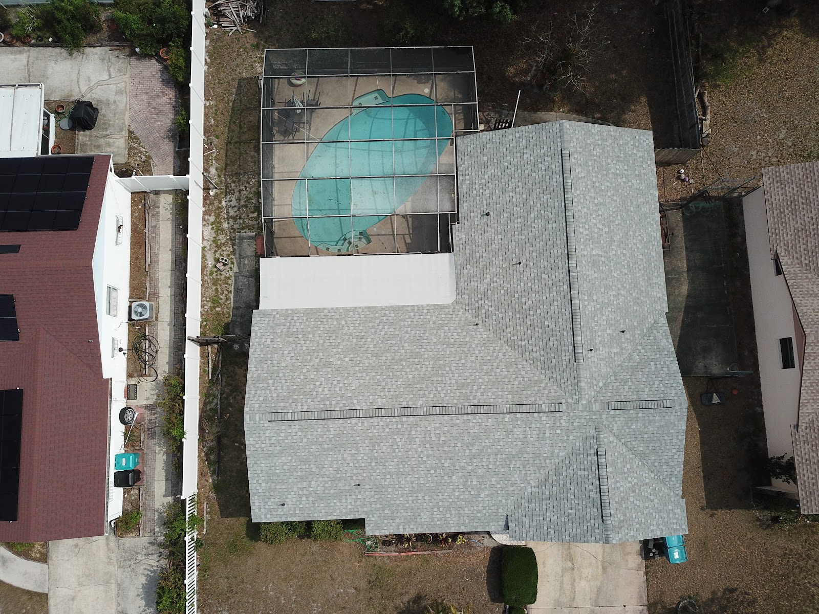 Aerial view of a completed gray architectural shingle re-roof on a Central Florida pool home