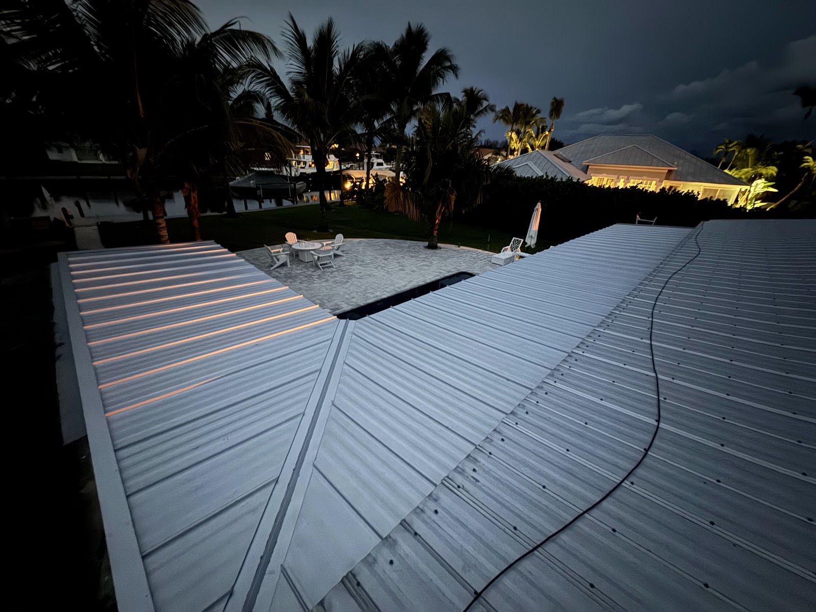 Ribbed metal panel roofing installed over a patio on a Central Florida waterfront home